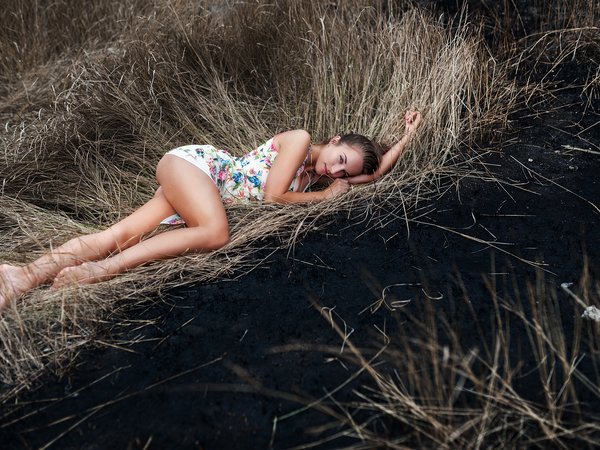 bare shoulders, barefoot, blue eyes, bokeh, brunette, depth of field, dress, dry grass, feet, girl, hairbun, legs, lips, lipstick, looking at camera, looking at viewer, lying on side, model, mouth, photo, portrait