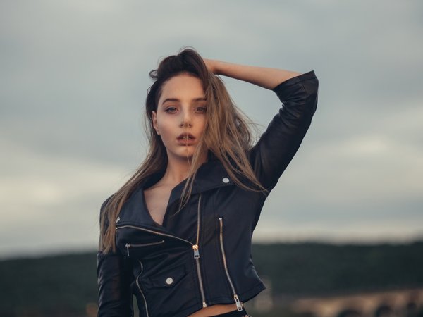 depth of field, hand on head, jacket, leather jacket, looking at viewer, model, one arm up, women, women outdoors, zipper