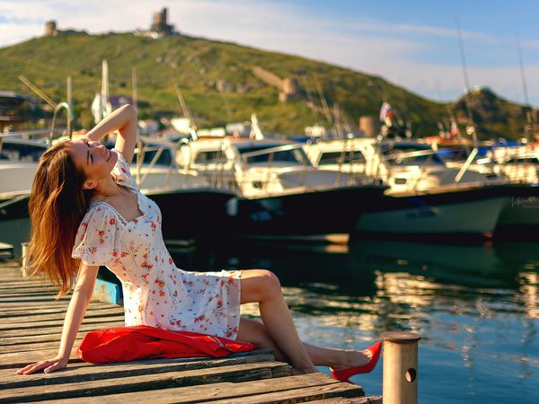 bay, boat, brunette, clouds, dress, heeled shoes, hill, jacket, model, nature, red jacket, red shoes, sitting, sky, smiling, white dress, women, women outdoors