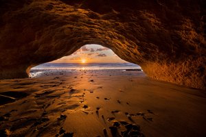 Обои на рабочий стол: beach, cave, clouds, horizon, landscape, nature, ocean, sand, sky, sun, sun rays, sunset, view from the cave, view from the cave cave, вид из пещеры, горизонт, закат, небо, облака, океан, пейзаж, песок, пещера, пляж, природа, солнечные лучи, солнце